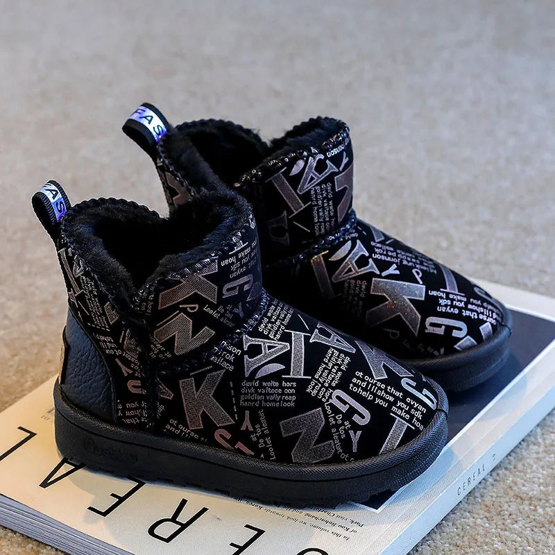 A pair of black girls' winter fur-lined snow boots with a non-slip sole resting on a light surface.