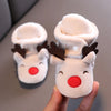 A pair of adorable animal-themed baby first walker shoes resembling reindeer heads made of soft white fleece.