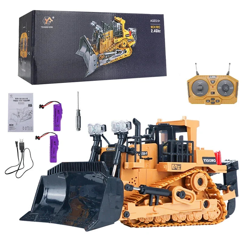 An orange remote control excavator toy with a black bucket and yellow details, shown with its packaging and accessories.