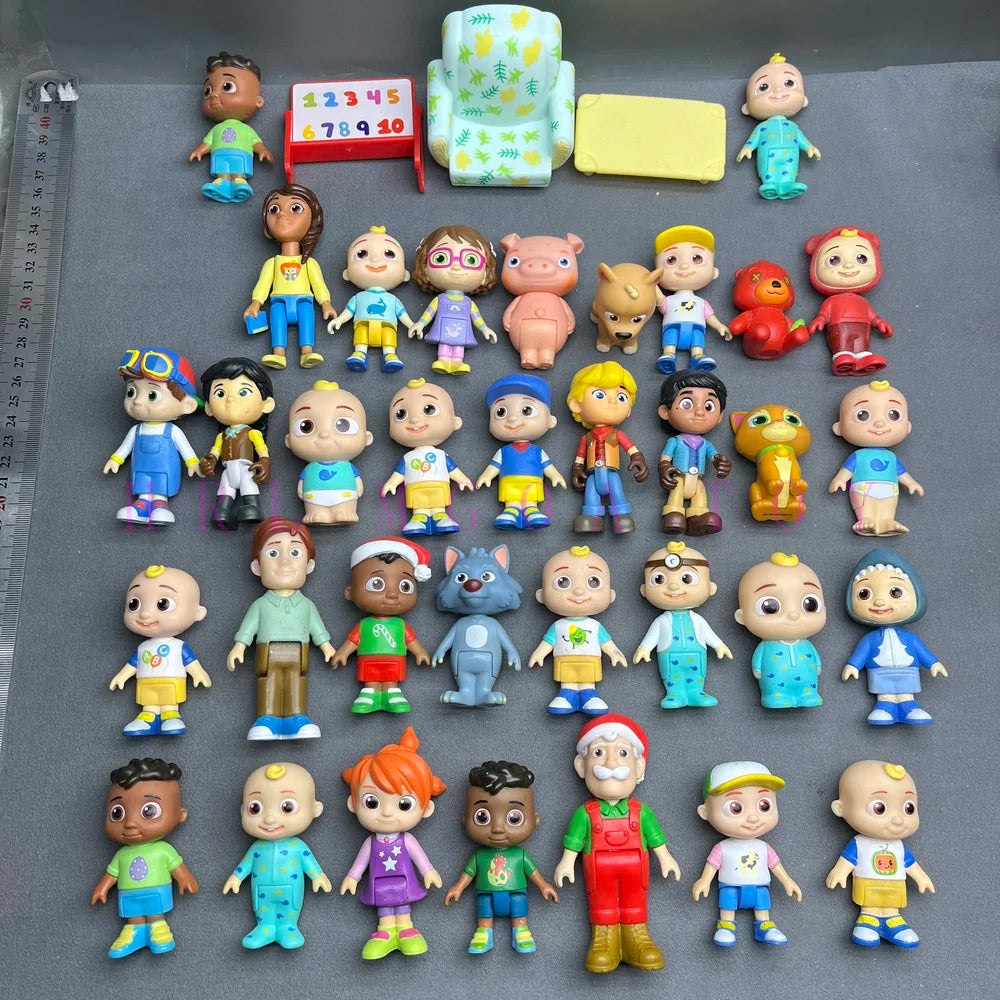 A collection of colorful PVC figurines featuring various cartoon characters and a watermelon school bus design.