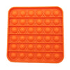 An orange silicone pop bubble sensory fidget toy with a grid pattern.
