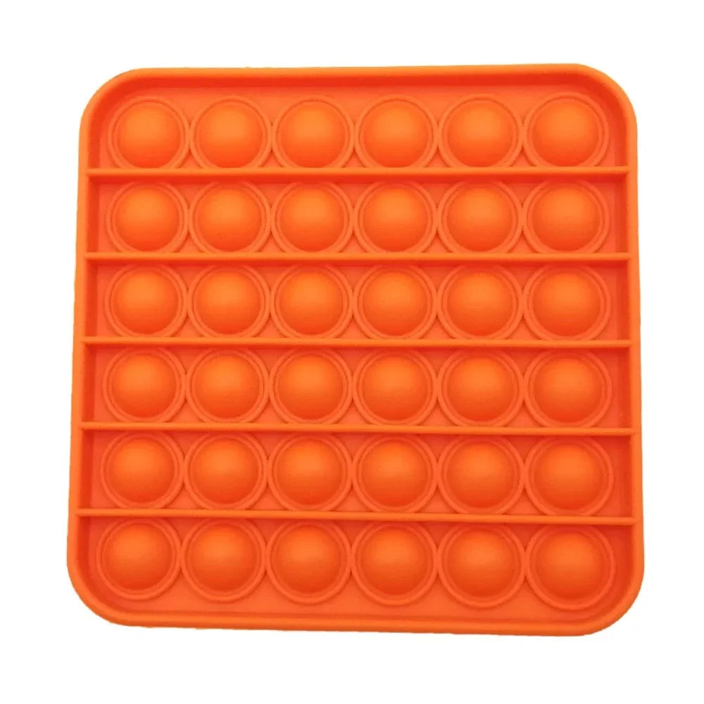 An orange silicone pop bubble sensory fidget toy with a grid pattern.