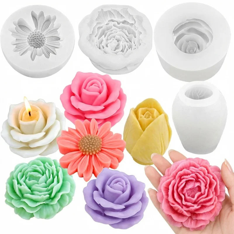 A set of four silicone flower molds in various colors including pink, yellow, orange, and purple, shown next to a hand.