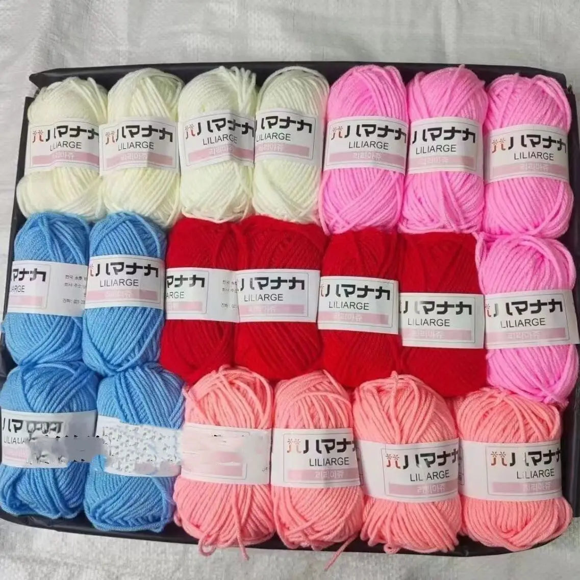 A pack of 12 skeins of various colored acrylic yarn for knitting and crochet crafts.
