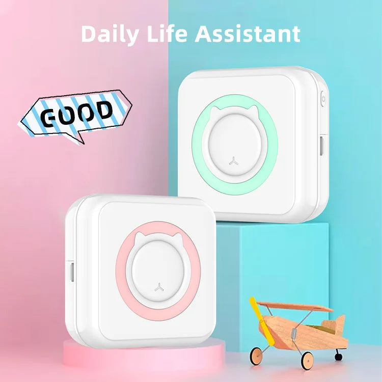 A white pocket thermal printer device is shown next to a pink stand and a wooden toy airplane.