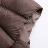 Close-up view of a dark brown padded down vest fabric.