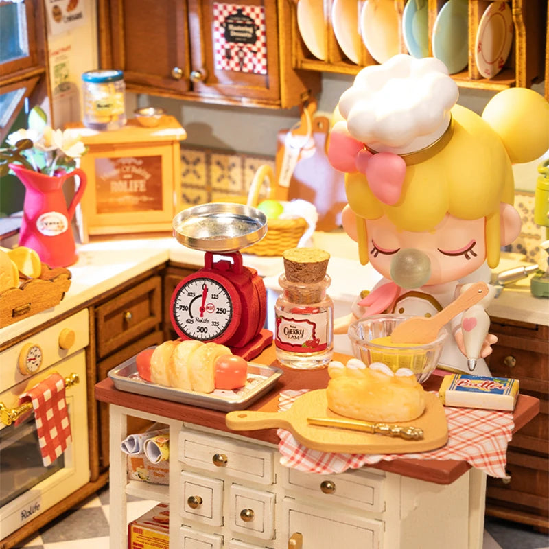 A miniature dollhouse kit featuring a cozy baking kitchen setup with various tools and food items.
