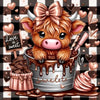 A cute, fluffy brown calf with pink nose and large eyes is featured in a silver pail covered in chocolate drizzle.