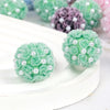 A close-up of light green rose flower balls made of acrylic beads for jewelry making