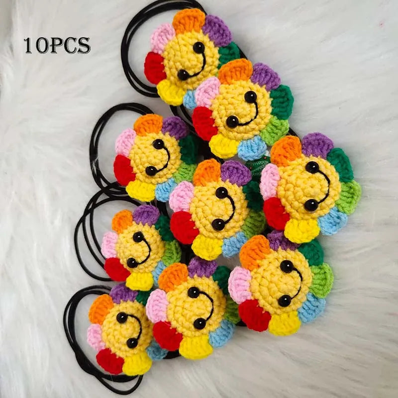Ten handmade crochet sunflower decorative smile orbs with black string.