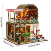 A wooden mini seaside villa dollhouse kit featuring a storefront, furniture, and decorative elements.