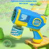 A blue and yellow electric bubble gun toy is shown with a bubble machine accessory on a wooden surface.
