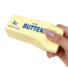 A hand holds a yellow salted butter squishy stick with '4oz' and 'BUTTER' printed on it.