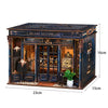 A dark blue vintage music room book nook kit featuring detailed miniature furniture and LED lighting.
