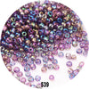 A close-up view of loose, colorful round Czech glass seed beads in various shades of purple and blue.