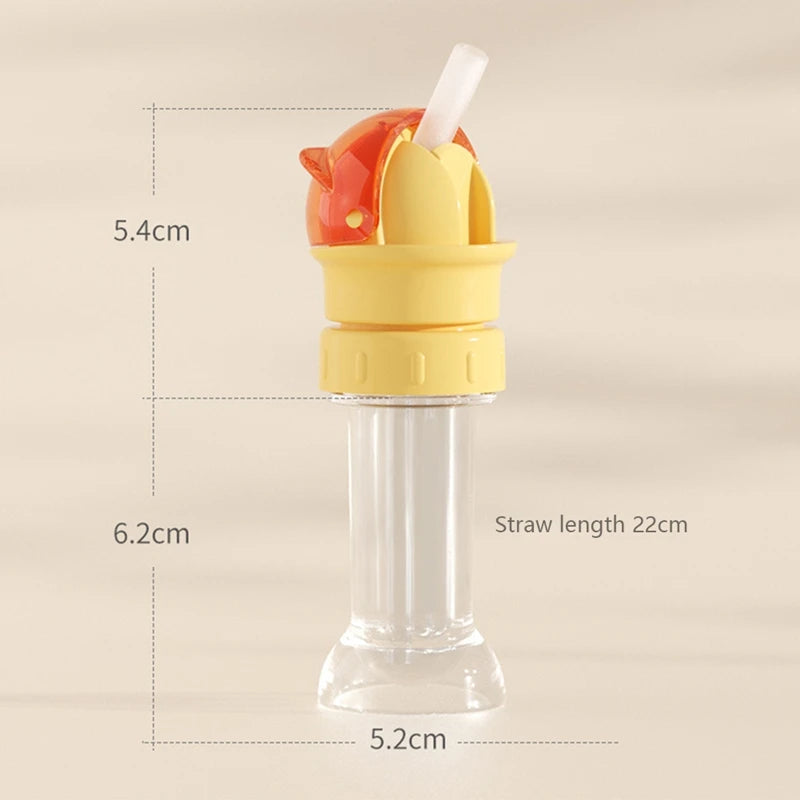 A clear glass bottle with a yellow converter and an orange bottle cap, featuring a white straw for kids.