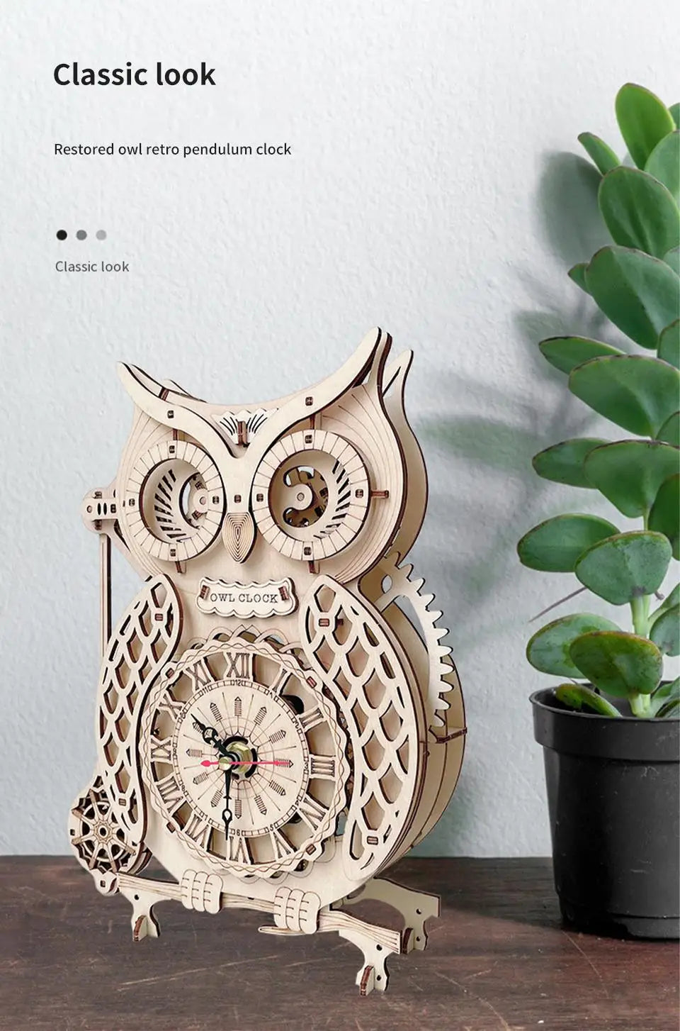 A restored wooden owl pendulum clock with intricate details displayed against a white wall.