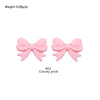 A pair of pink silicone bow tie beads used for jewelry making and craft projects.