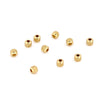 A collection of small gold stainless steel round spacer beads for jewelry making.