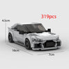 A model of a white classic supercar built from LEGO bricks, shown in a side view.