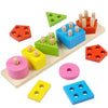 A collection of wooden geometric shape sorter puzzles in various colors including green, blue, orange, and pink.