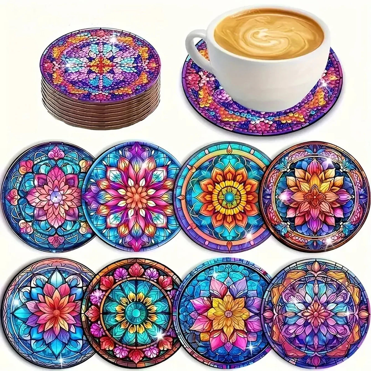 A collection of colorful diamond art coasters and a white coffee cup with latte art.