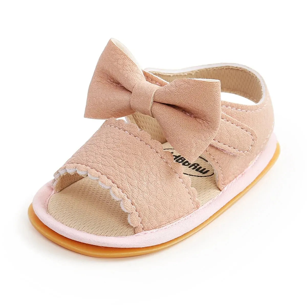 A pair of light pink baby summer sandals with a bowknot and soft anti-slip sole.