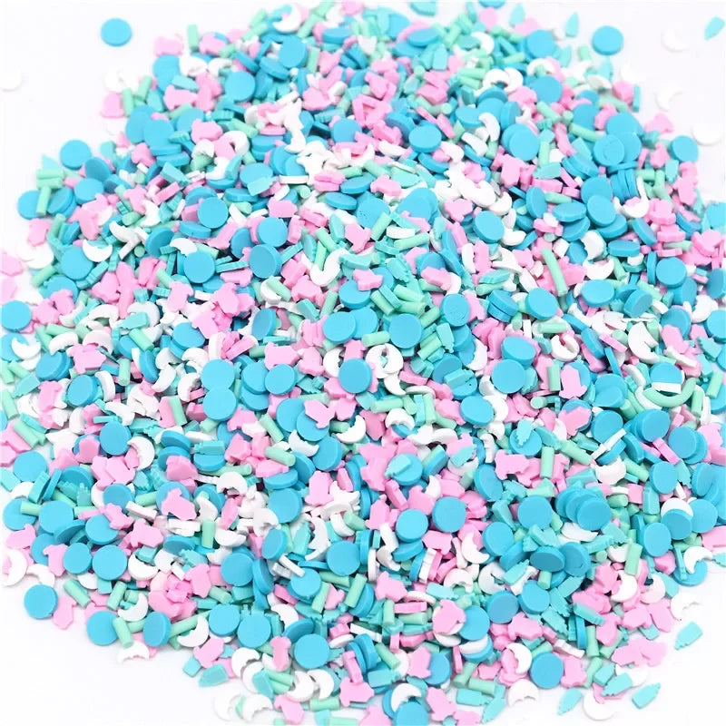 A pile of colorful polymer clay flower charms in various shades of pink, blue, and white.