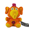 An orange and yellow plush toy resembling an elephant character with large ears and a purple hat.