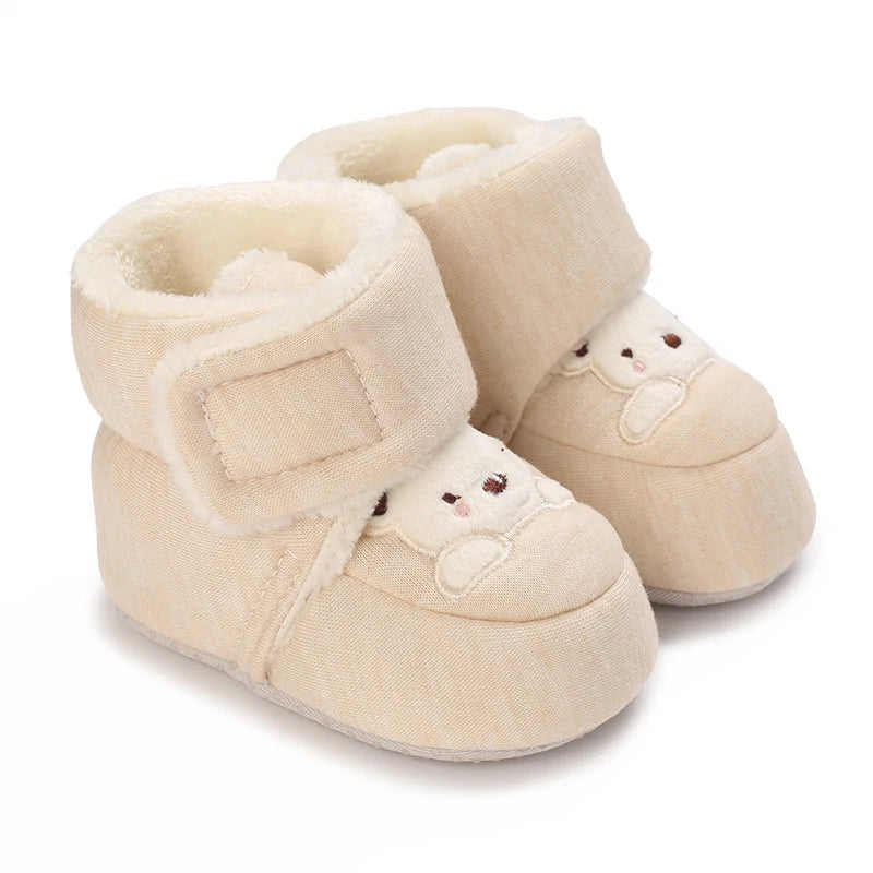 Pair of beige baby winter cartoon boots with soft lining and non-slip sole
