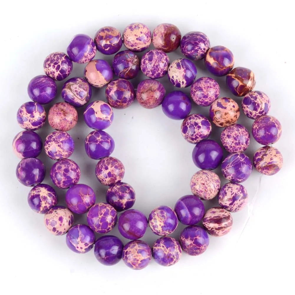 A strand of small, round beads made from natural sea sediment jasper and turquoise for jewelry making