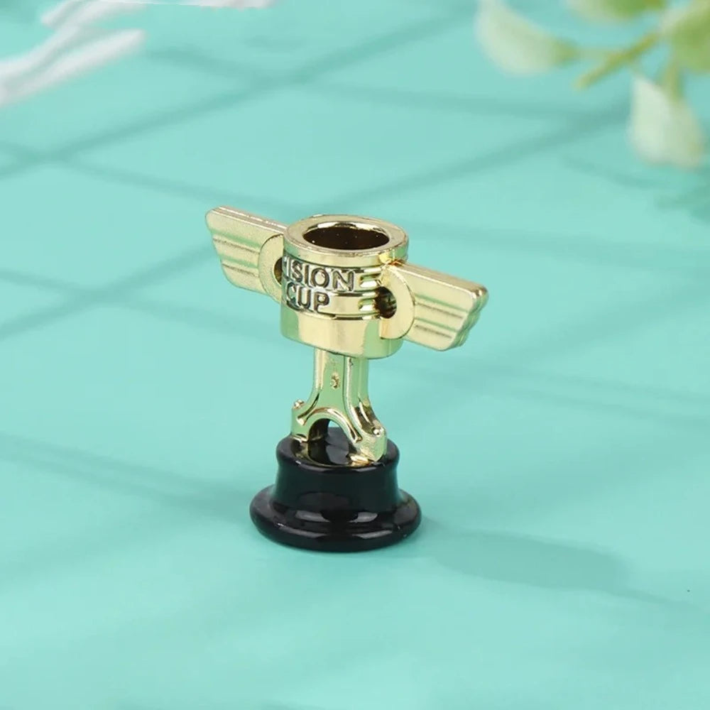 A small golden trophy cup with a gold base and a black stand, suitable for kids and events.