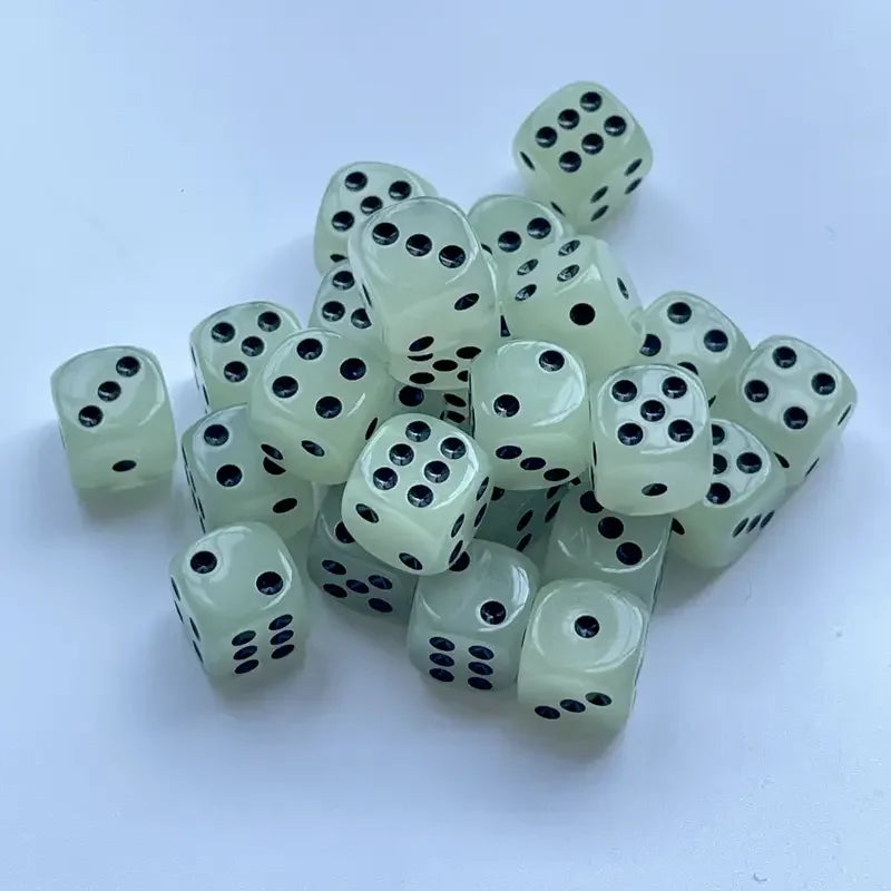 A pile of ten glow-in-the-dark dice in a pale green color scattered on a white surface.