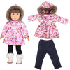 A doll wearing a pink and purple floral winter coat and matching pants with a faux fur hood.
