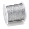 A spool of silver metallic craft cord for jewelry making