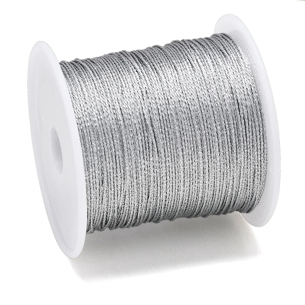 A spool of silver metallic craft cord for jewelry making
