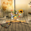 A glowing LED message board displays spring-themed illustrations and is positioned on a table with color pens.