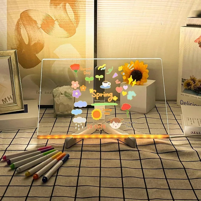 A glowing LED message board displays spring-themed illustrations and is positioned on a table with color pens.