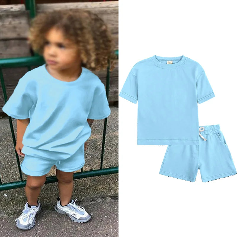 A light blue kids summer tracksuit set featuring a short sleeve top and matching shorts.