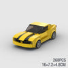 A yellow classic rally car building block set with black racing stripes, shown from the side.
