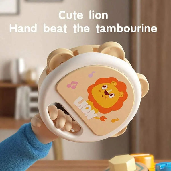 A cute lion hand beat the tambourine instrument.
