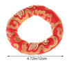 Handmade red singing bowl cushion featuring gold embroidery