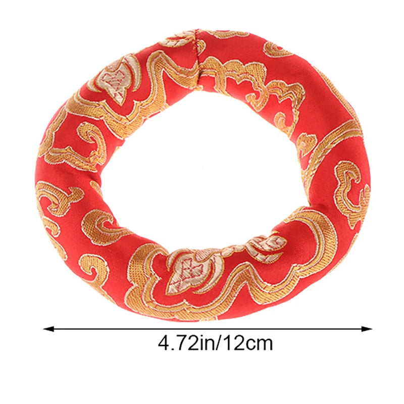Handmade red singing bowl cushion featuring gold embroidery