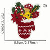 A festive cartoon character iron-on patch depicting a red Christmas stocking with green holly and a yellow bow.