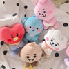 A collection of pink and blue kawaii anime mini plush keychains resting on a white polka-dot surface.