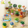 A set of DIY flower succulent building blocks in various colors and sizes displayed on a wooden surface.
