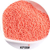 A pile of small, round, coral pink glass seed beads for jewelry and craft.