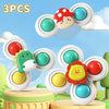 Drei Saugnapf-Spinner-Spielzeuge mit Pilz und Dinosaurier auf blauem Hintergrund.