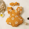 A yellow floral ruffle bodysuit for a baby girl is displayed on a light background with a bow nearby.