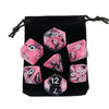 A set of pink and black marbled polyhedral dice stored in a black fabric bag.